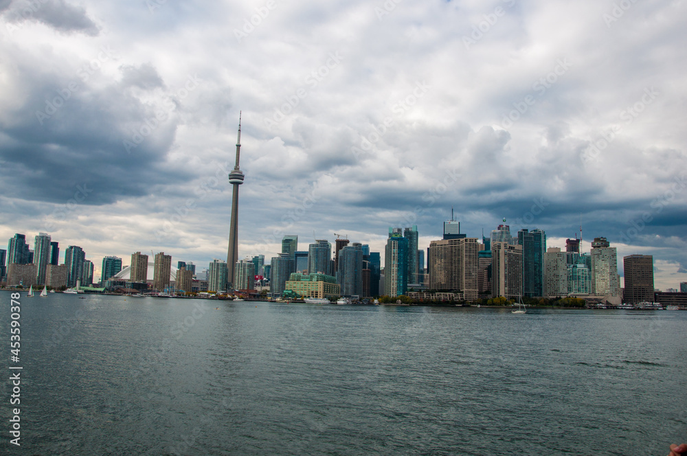 Poster Scenic view of toronto city with skyscrapers and ontario lake  at gloomy day- canada