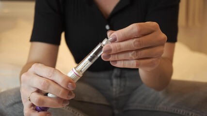 Woman preparing pen syringe for Egg freezing , FSH Stimulating Hormone treatment to stimulate the ovaries to produce more eggs, initial process for fertility treatment. mature oocyte cryopreservation
