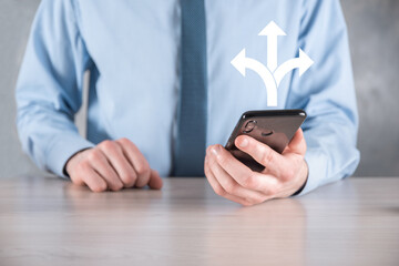 Businessman in a suit holds a sign showing three directions. in doubt, having to choose between three different choices indicated by arrows pointing in opposite direction concept. three ways to choose