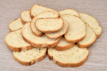 Stack of sliced fresh homemade white bread on the rustic wooden table.