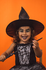 Little girl dressed as a witch for Halloween