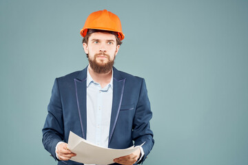 male engineer documents in hand and drawings protective uniform
