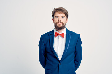 man in suit red bow tie posing