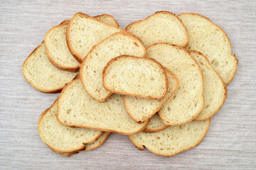 Stack of sliced fresh homemade white bread on the rustic wooden table. Top view.