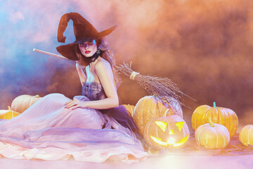 beautiful witch with pumpkins