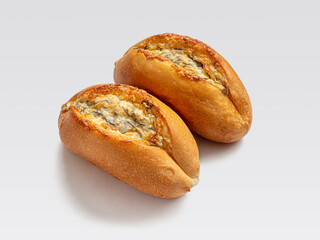 Two buns with herbs, garlic and cheese on a light background