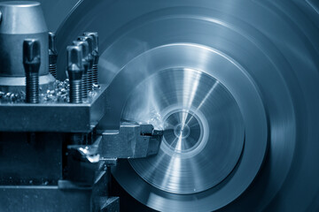 Fototapeta premium The lathe machine operation by face cutting metal parts by lathe tools.