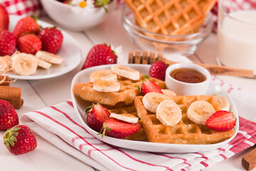 Waffles with strawberries, bananas and honey.