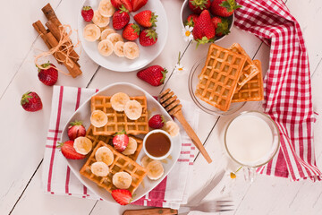 Waffles with strawberries, bananas and honey.