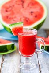 Delicious healthy refreshing low calories summer drink: watermelon smoothie or juice. Concept of seasonal desserts, detox, dieting. White wooden background, close up, macro
