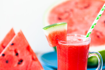 Delicious healthy refreshing low calories summer drink: watermelon smoothie or juice. Concept of seasonal desserts, detox, dieting. White wooden background, close up, macro