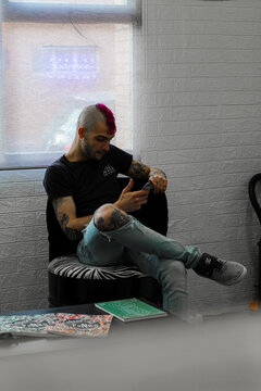 tattooist in a telephone conversation with a customer