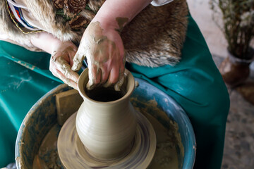 the process of creating a water jug on a potter's wheel. hands of a clay master