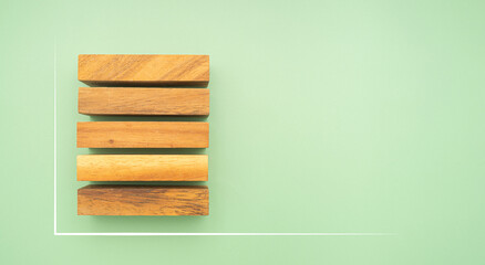 Top view of five empty wooden blocks with line effect isolated on a green background. Space for text