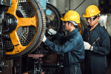 team engineer mechanic man checking and using wrench for maintenance pressing metal machine at...