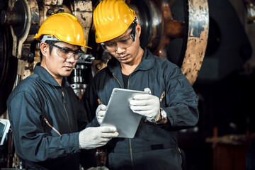 	
team engineer mechanic man wearing protective face mask and checking plan on tablet for maintenance metal machine at factory, teamwork concept	
