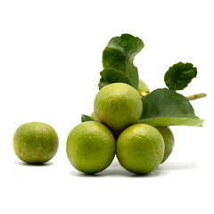 Bunch of green lemons with leaves isolated on white background