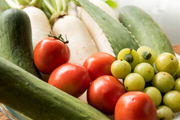 Cucumber,tomato,radish and Indian Gooseberry on nature background.