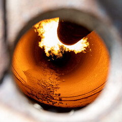 Rotary kiln for clinker production in cement plant, close up view through inspection hole