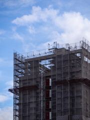 Building under construction, cranes and high-rise building