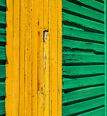 Macro texture of old faded paint on wooden timber planks