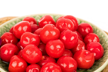 Candied cherry fruits isolated on white surface.