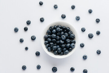 Beautiful ripe blueberries in a glass bowl on a white background. Healthy food, and vitamins.