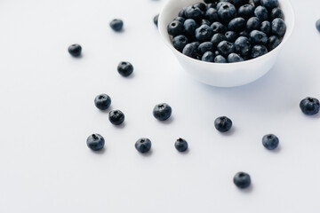 Beautiful ripe blueberries in a glass bowl on a white background. Healthy food, and vitamins.