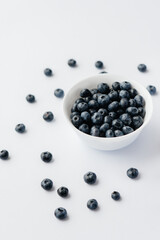 Beautiful ripe blueberries in a glass bowl on a white background. Healthy food, and vitamins.