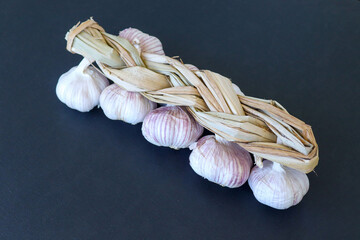 Garlic braid on dark background