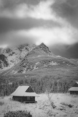 Dramatic mood in Hala Gąsienicowa Valley, High Tatra Mountains, Poland. Black and white winter failytale. Selective focus on the summit, blurred background.
