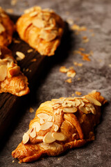 freshly baked croissants topping almond set of delicious fresh in plates wooden table. French breakfast