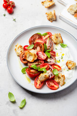 salad with tomatoes, stracciatella, ciabatta and basil