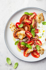 salad with tomatoes, stracciatella, ciabatta and basil