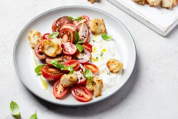 salad with tomatoes, stracciatella, ciabatta and basil