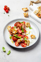 salad with tomatoes, stracciatella, ciabatta and basil