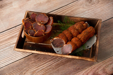 Homemade jerked dried meat or biltong with spices on a wooden background. Beer snack concept....