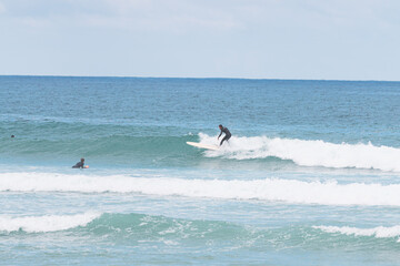 Longboard surfer in les casernes beach, seignosse, landes, france
