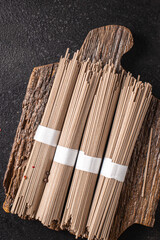 soba raw buckwheat noodles ready to cook portion meal snack on the table copy space food background rustic 