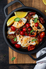 codfish with tomato sauce in a iron pan