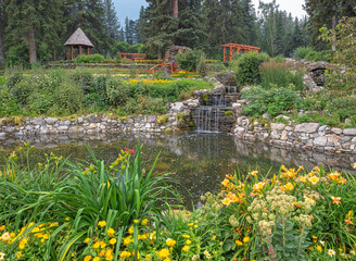 View of a waterfall with gazebo and bridge in the Cascade public gardens in Banff, Alberta, Canada