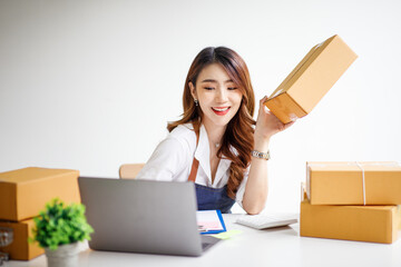 Portrait of Starting small businesses SME owners female entrepreneurs working on receipt box and check online orders to prepare to pack the boxes, sell to customers, sme business ideas online.