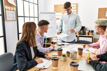 Group of business workers listening hispanic boss man conference at the office.