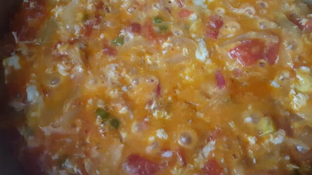 Menemen dish made with onions, peppers, tomatoes and eggs