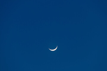 Obraz na płótnie Canvas Crescent moon on blue sky. Look like a smile on a good day.