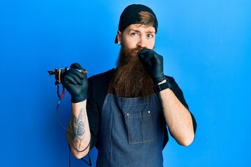 Redhead man with long beard tattoo artist wearing professional uniform and gloves mouth and lips...