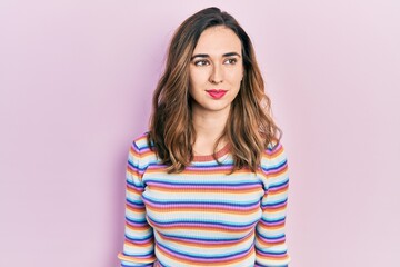 Fototapeta premium Young hispanic girl wearing casual clothes smiling looking to the side and staring away thinking.