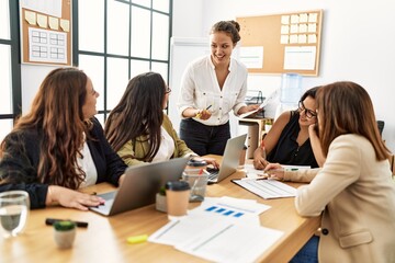 Group of young businesswomen listening boss during meeting at the office.