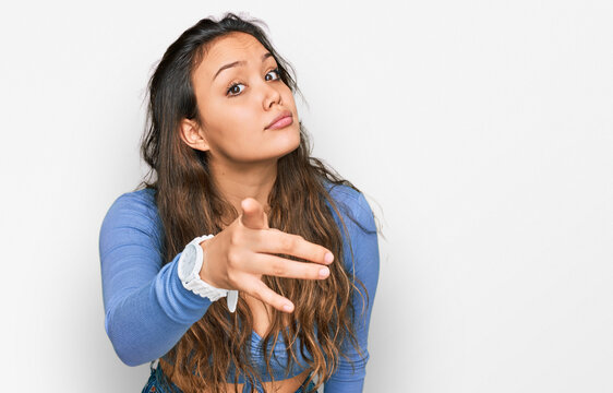 Young hispanic girl wearing casual clothes pointing displeased and frustrated to the camera, angry and furious with you