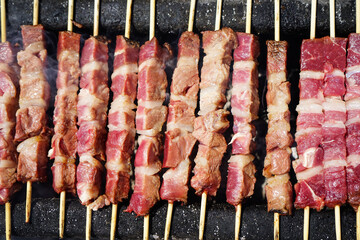 Typical sheep skewers (arrosticini) cooking on the barbecue